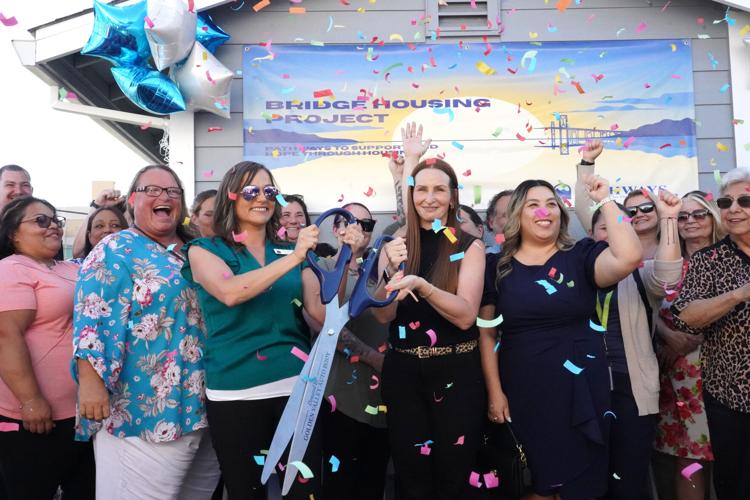 Executive director of Pathways, Laci Bradfield, and Prevention Instructor Sarah Higgins are pictured holding scissors during a Yuba-Sutter Chamber of Commerce ribbon cutting ceremony on July 17 for the new transitional housing rooms that are at the site of Pathways’ treatment facility in Marysville.